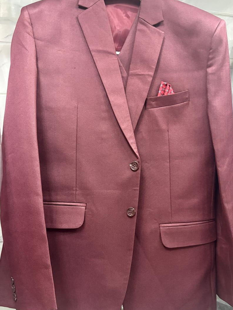 A dusty rose or mauve-colored men's blazer jacket with notch lapels, two front buttons, flap pockets, and a matching pocket square, displayed on a hanger.
